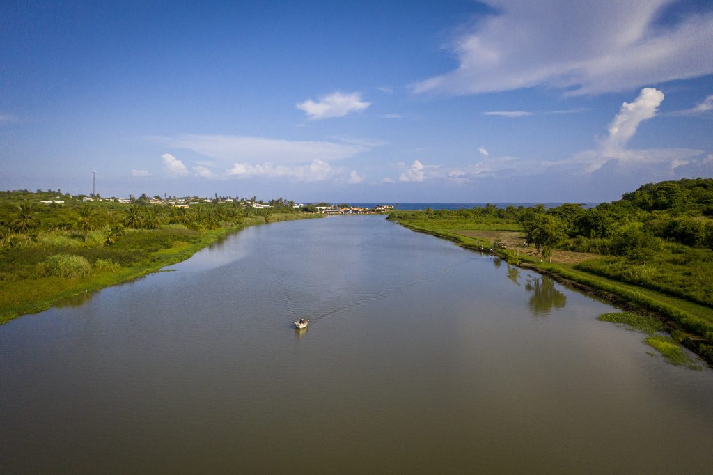 A birds eye view of a large river leading to the ocean